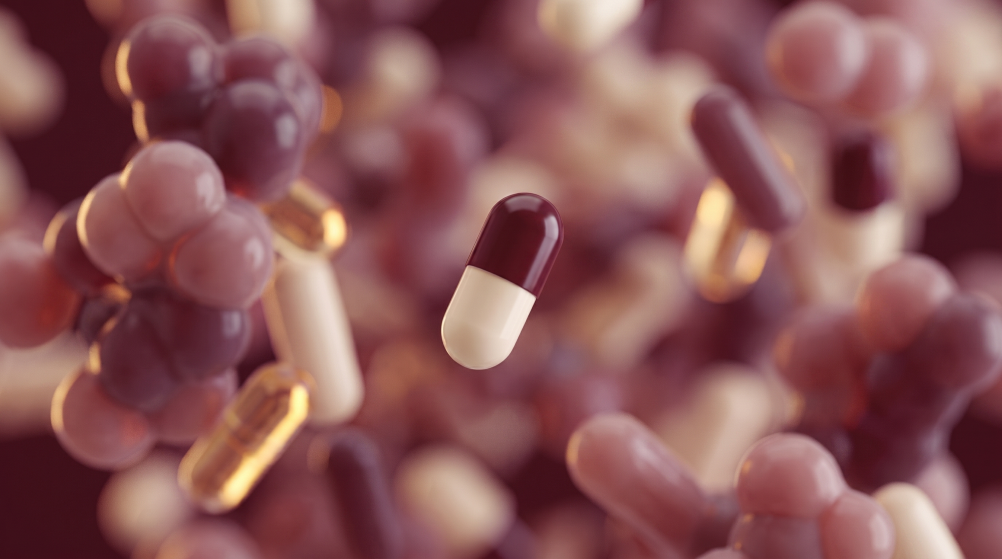 Macro render of maroon capsules amid microbial forms.